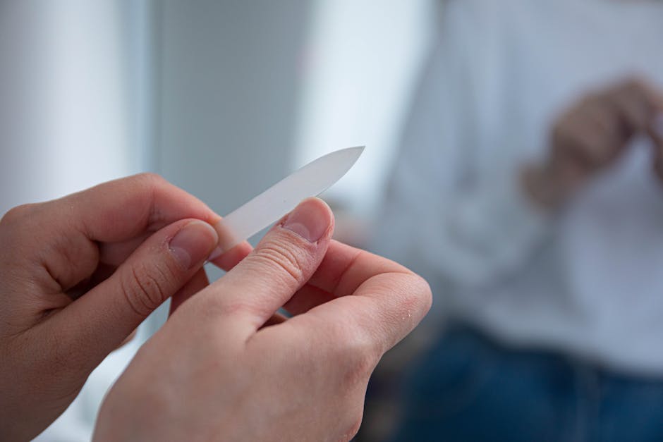 Close-up of a person filing their nails