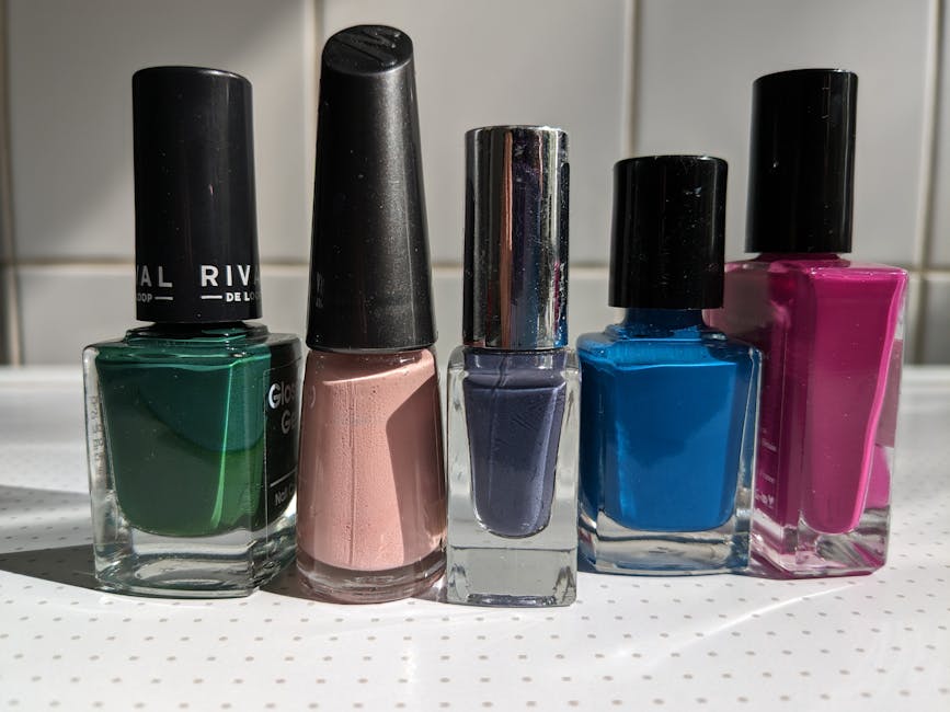 Colorful nail polish bottles on a white surface