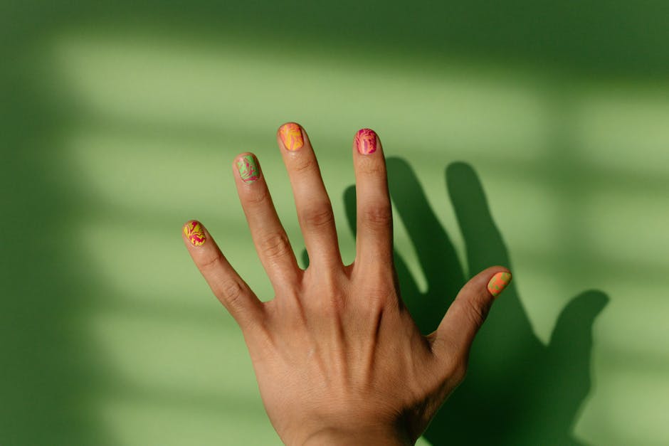 Left hand showing nail-art designs