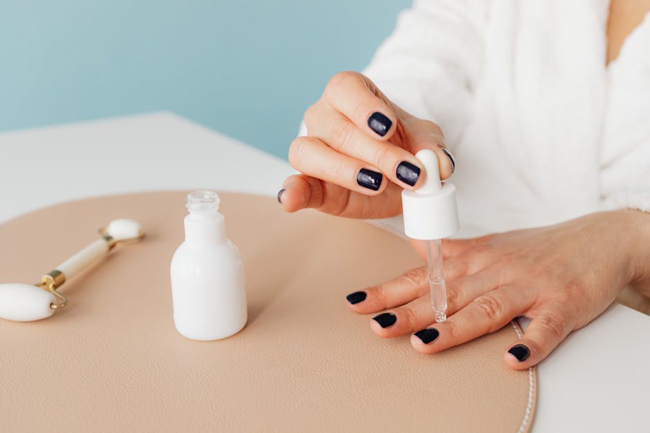 Woman applying cuticle oil to nails