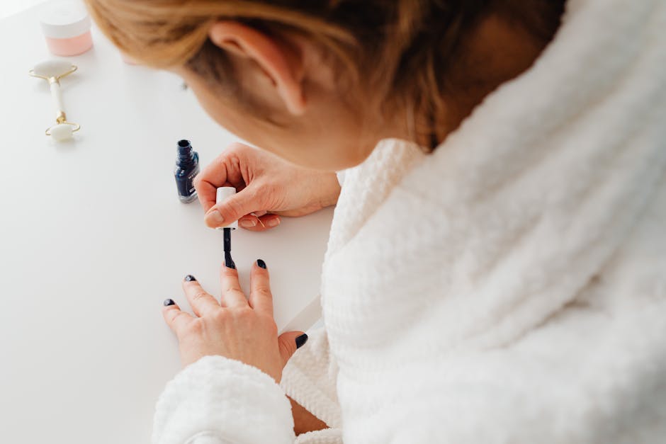 Woman painting her nails at home