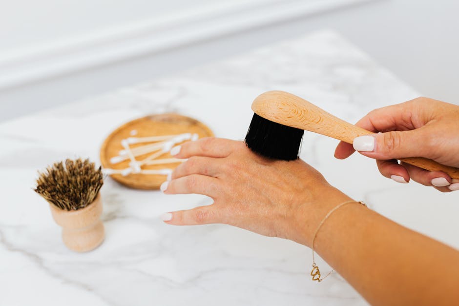 Wooden nail brush brushing across the back of a hand